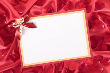 Valentine card with ribbon and rose petals
