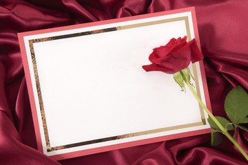 Valentine card with rose on red satin background