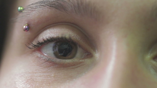 woman moves her brown eye