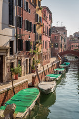 Fototapeta na wymiar Few boats on a canal in Venice