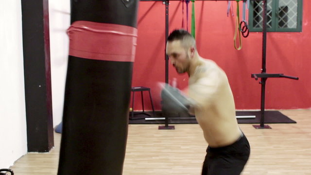 boxer trains with the punching bag - boxe