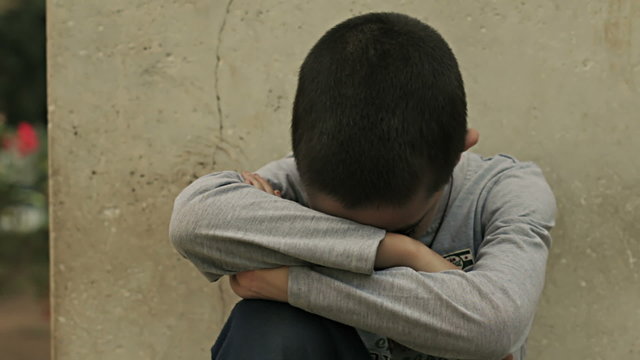 sad and unhappy child in the park