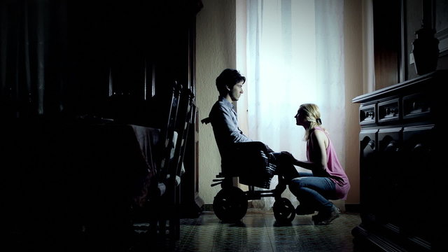 health visitor encourages a disabled on wheelchair - handicapped