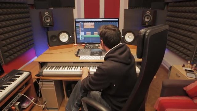 sound designer in his recording studio - tracking shot