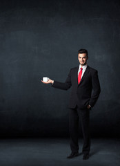 Businessman holding a white cup