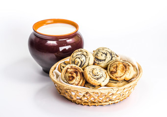 isolated bread basket with jug of milk