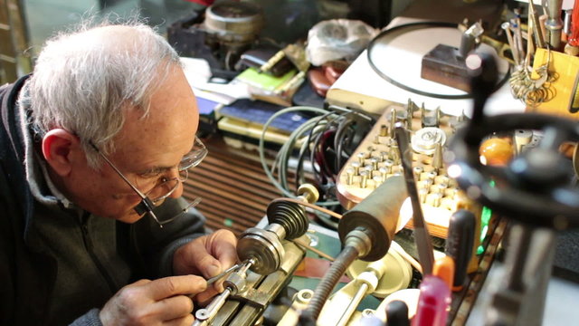 watchmaker working with the lathe