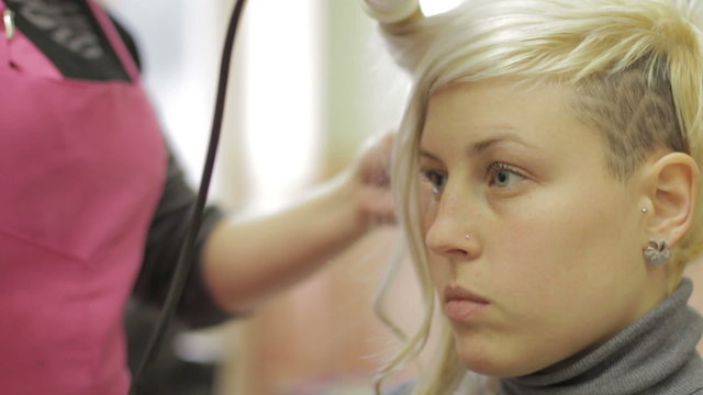 a young woman  gets her hair done - hairdresser - hairstylist