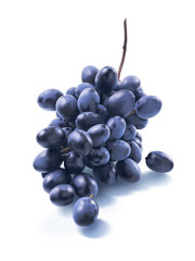 Tiny dry blue grapes bunch isolated on white