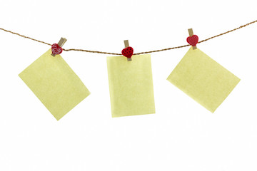 Blank paper note hanging on rope .