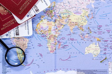 open world map with magnifying glass and passports