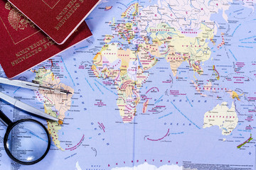 open world map with magnifying glass, compasses and passport