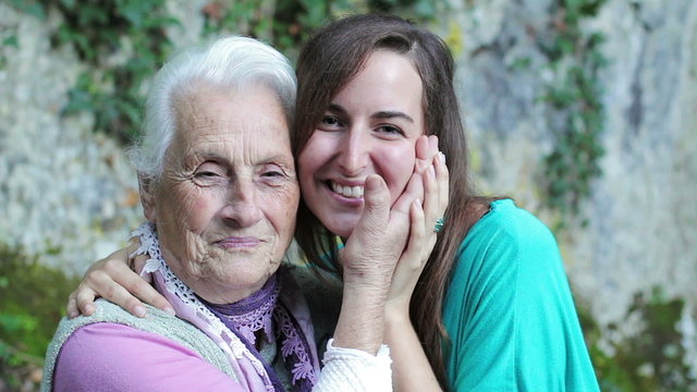Grandmother and granddaughter giving each other a cuddle full of love