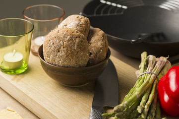 Bread on Bowl on Board with Glasses and Knife