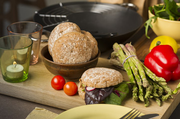 Fresh vegetables and rolls in a kitchen