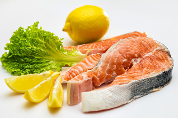 Raw Salmon Red Fish Steak with Herbs and Lemon isolated on White