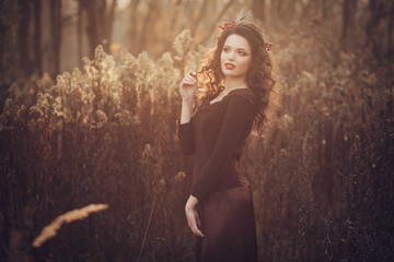 Fototapeta premium Young tender woman admires the sunset