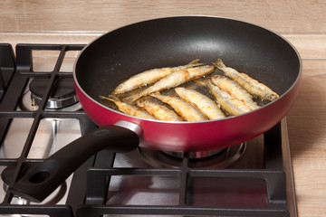Fish is fried in a pan