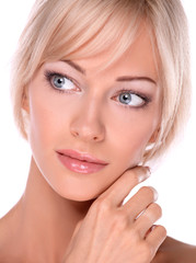 Portrait of young woman touching her face isolated on white