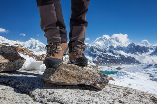 Hiking boot closeup on mountain rocks