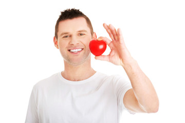 Young man holding a red heart