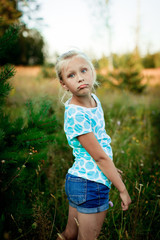 Portrait of beautiful little girl in a meadow 
