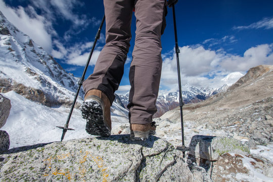 Hiking boot closeup on mountain rocks