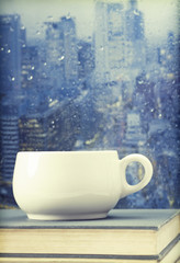 Coffee cup on a rainy day in front of the window