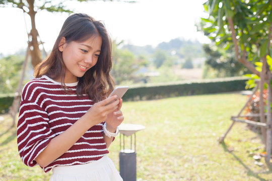 portrait of young beautiful woman reading message text on mobile