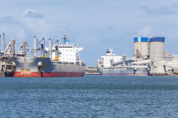 Cargo ships unloading at a port