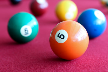 billiard balls in a pool red  table.