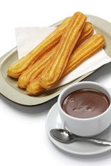 churros and hot chocolate on white background