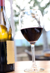 Composition with wineglass and bottle of red wine