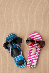 Loving couple of flip flops on the sand