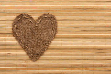 The symbolic heart of burlap lies on a bamboo mat