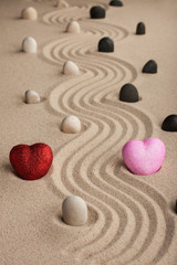 Fototapeta na wymiar Two conceptual heart in the sand
