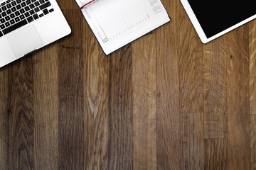 digital tablet pc, computer, calendar notebook on wooden table