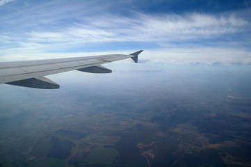 Fototapeta na wymiar airplane flying high in the blue sky
