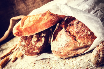 Selection of freshly baked bread in paper bag