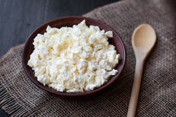 Delicious homemade cottage cheese on the wooden table