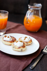 Delicious homemade cheese pancakes with fresh carrot juice