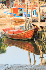 Fototapeta na wymiar wooden fishing boat with reflection in water