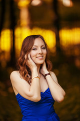 Young cheerful woman posing in park