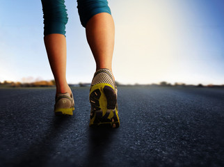a woman with an athletic pair of legs going for a jog or run