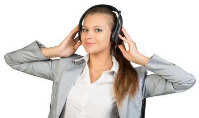Businesswoman in headset with her hands on speakers