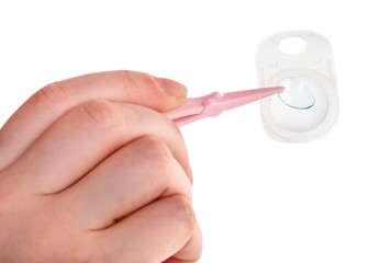 woman taking contact lens by forceps
