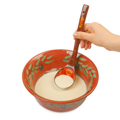 The batter for pancakes in traditional ceramic bowl