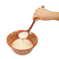The batter for pancakes in traditional ceramic bowl