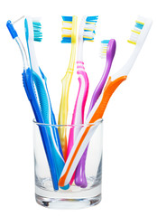 toothbrushes and interdental brush in clear glass