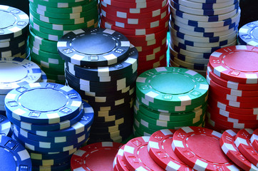 Red, blue, green, white and black poker chips pile